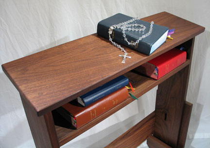 Prayer bench with prayer books and rosary